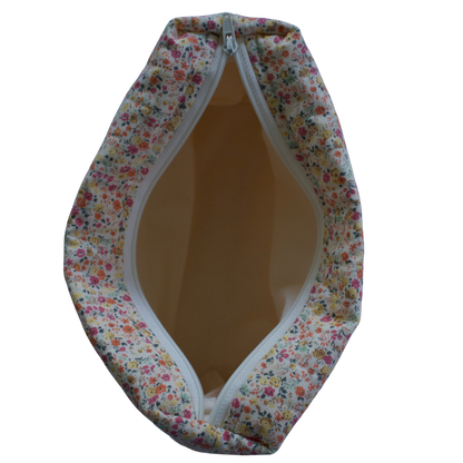 Floral-patterned fabric cover with a zipper on a white background