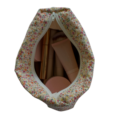 Floral-patterned fabric cover with a zipper for cardboard boxes on a white background