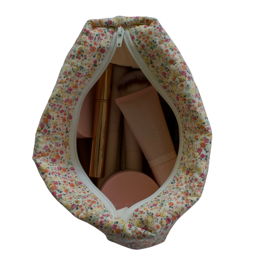 Floral-patterned fabric cover with a zipper for cardboard boxes on a white background