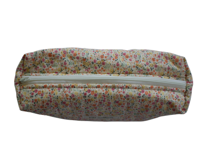 Floral-patterned travel pouch with a zipper on a white background