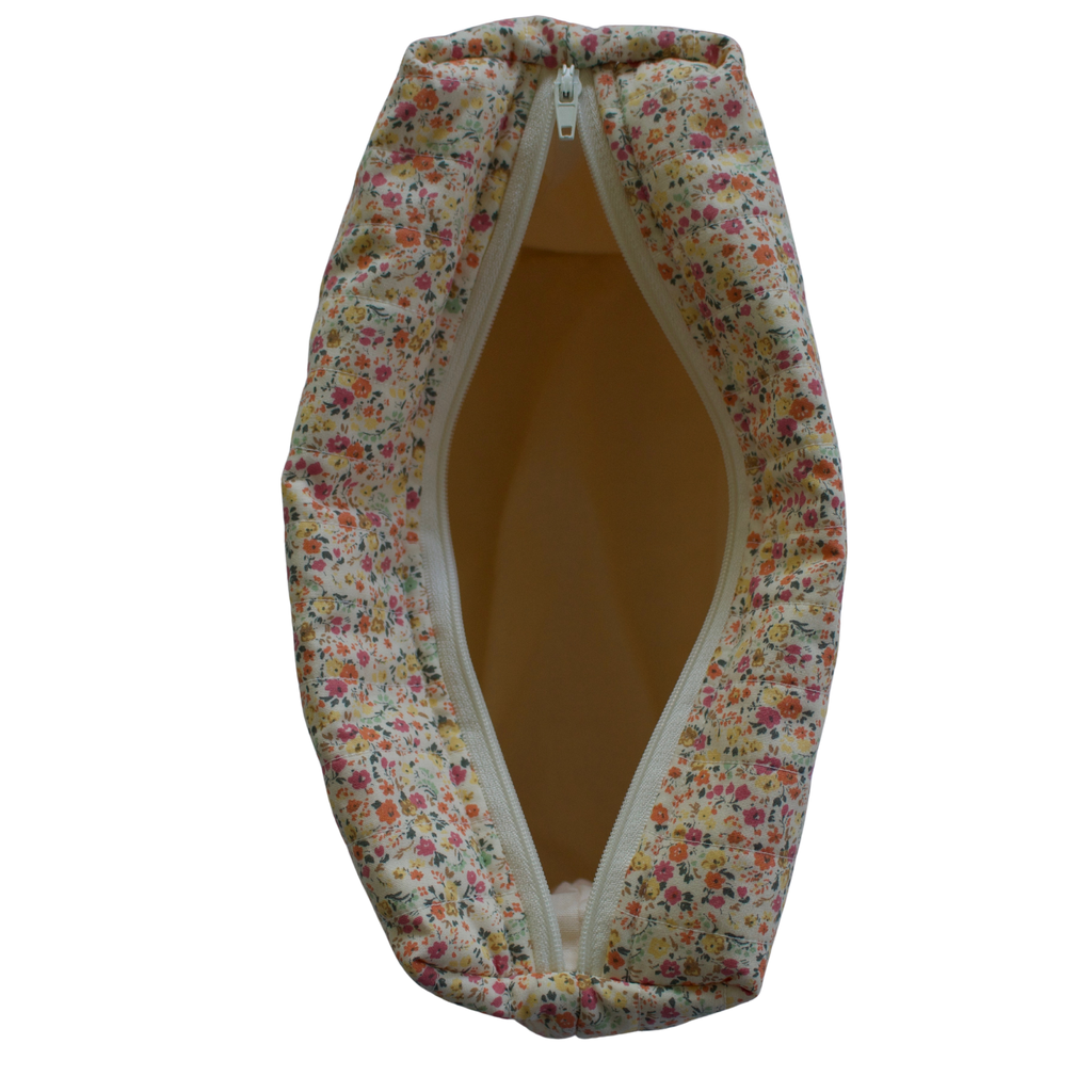 Floral-patterned fabric bag with a zipper on a white background travel pouch