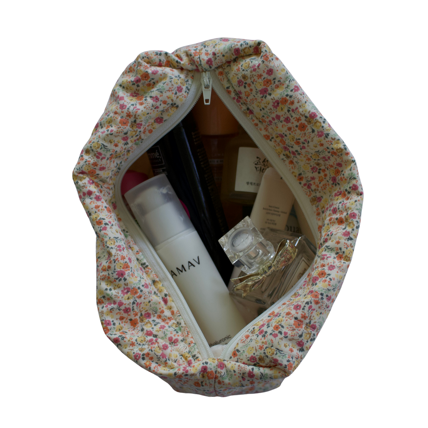 Floral-patterned travel bag with toiletries on a white background travel pouch
