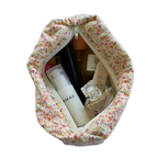 Floral-patterned makeup bag with skincare products on a white background beauty pouch