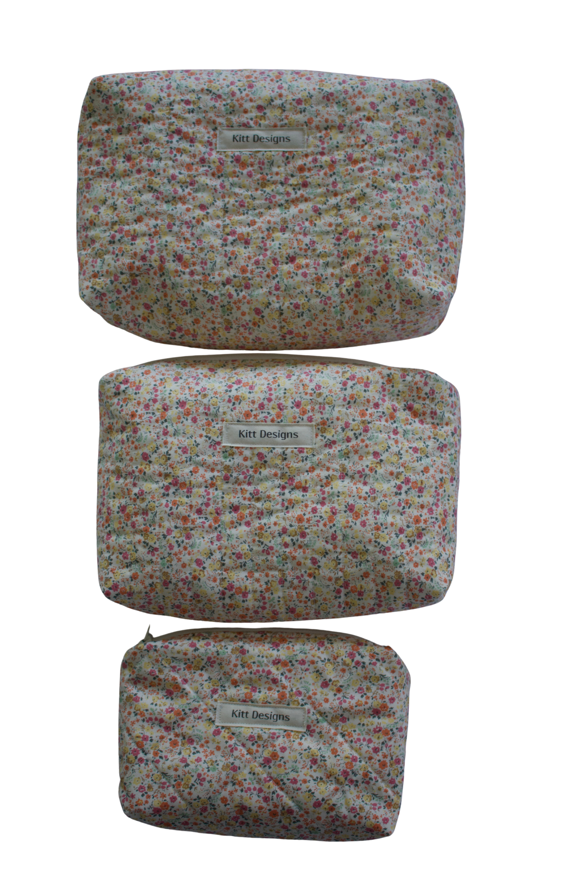 Set of three floral-patterned pouches with a visible brand label on a white background