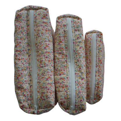 Three floral-patterned fabric rolls with zippers on a white background mini pouch beauty pouch travel pouch