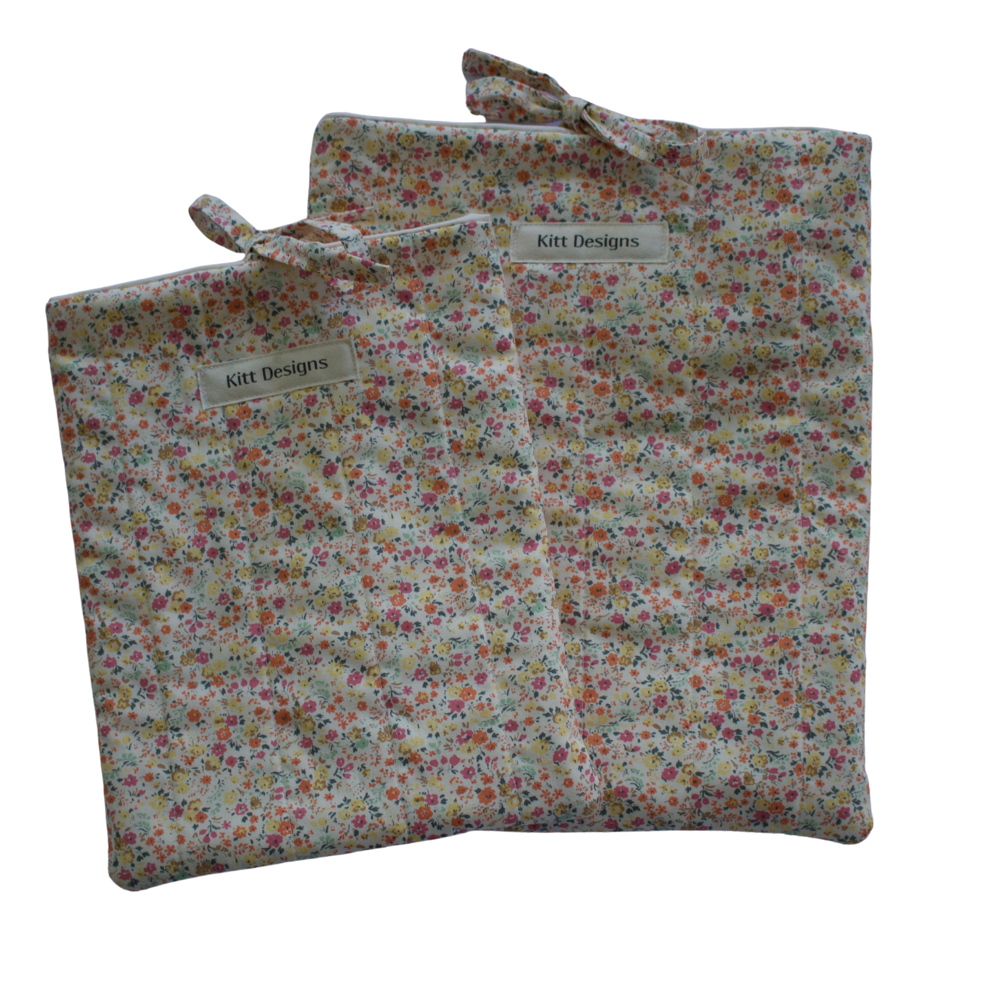 Floral-patterned fabric bag with a visible brand label on a white background