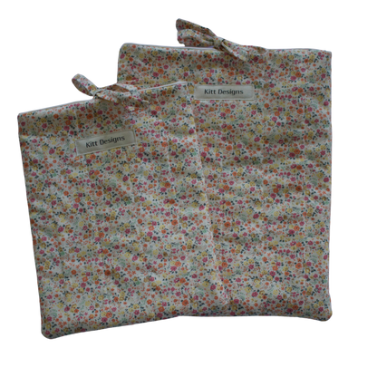 Floral-patterned fabric bag with a visible brand label on a white background
