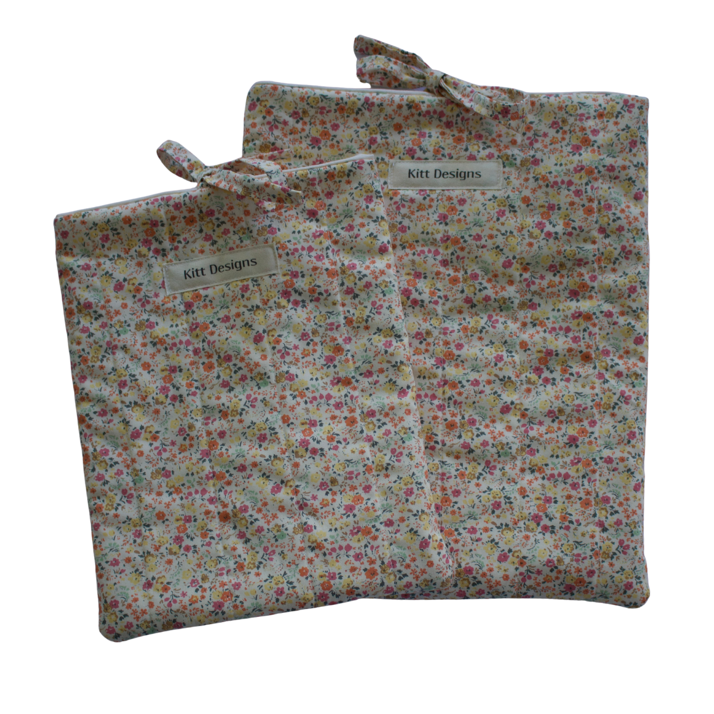 Floral-patterned fabric bag with a visible brand label on a white background