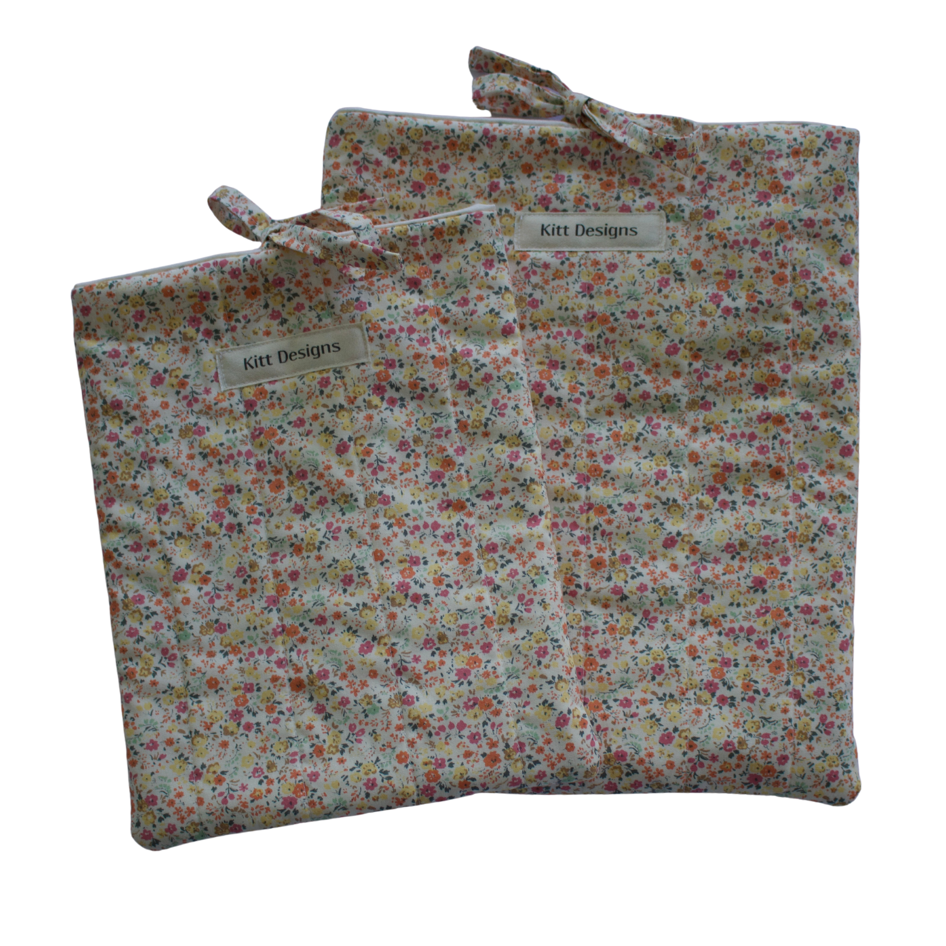 Floral-patterned fabric bag with a visible brand label on a white background