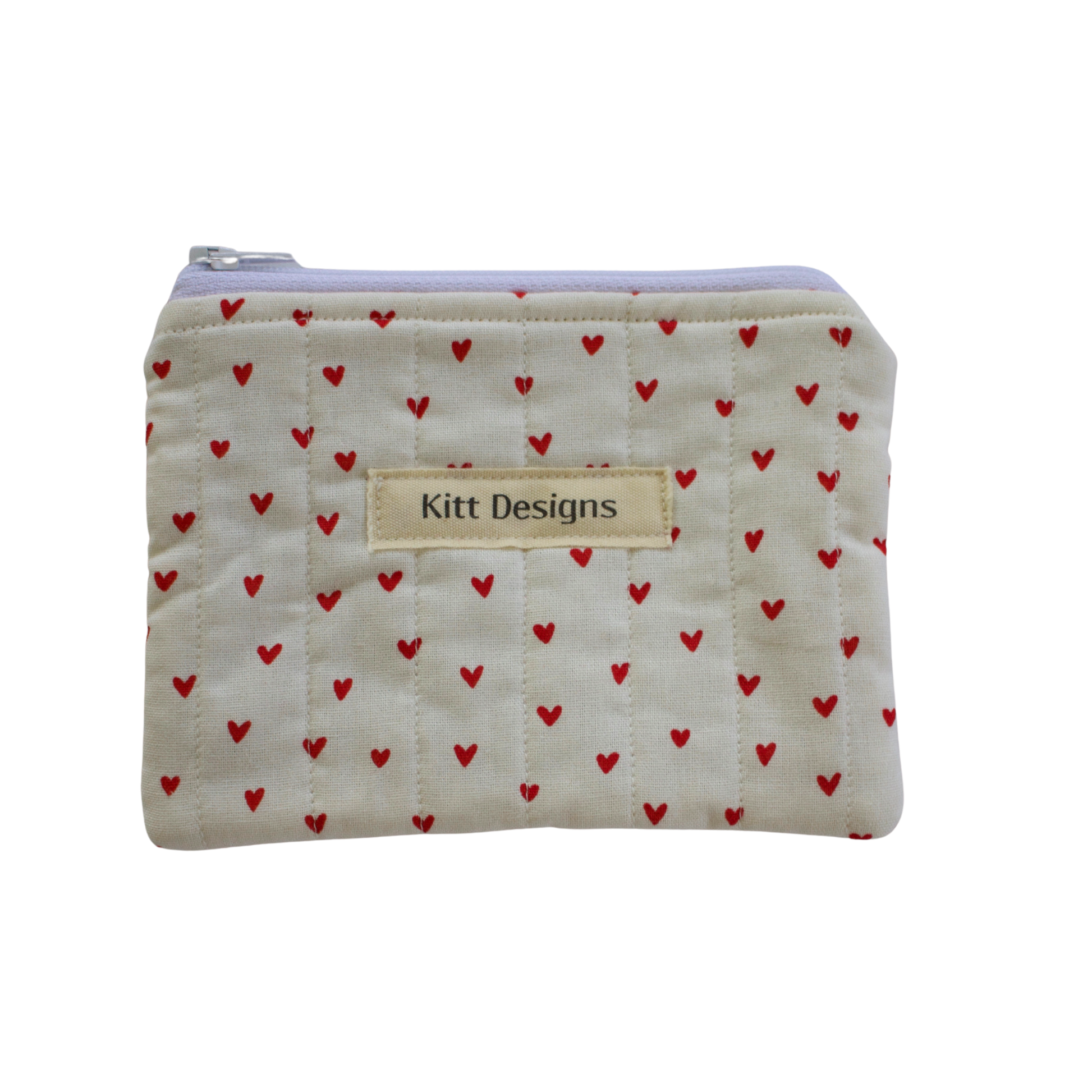 Small pouch with red heart pattern and 'Kitt Designs' label coin pouch