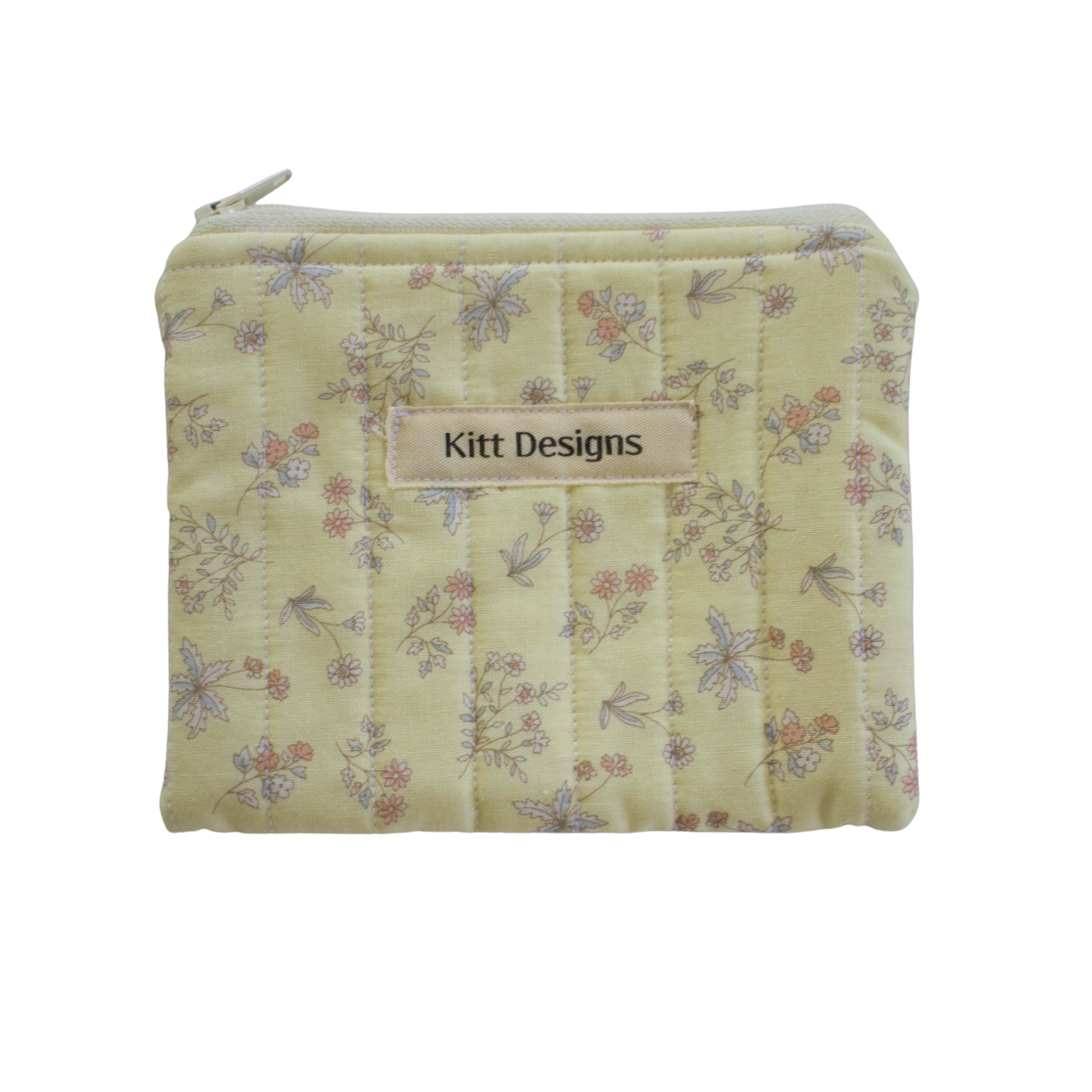 Floral patterned pouch with 'Kitt Designs' label coin pouch
