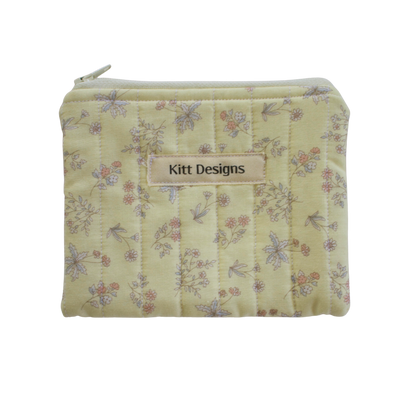 Floral patterned pouch with 'Kitt Designs' label coin pouch