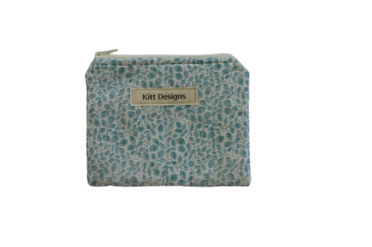 Small pouch with teal pattern and 'Kitt Designs' label coin pouch