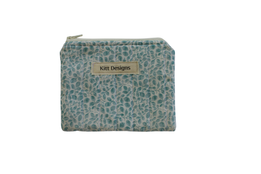 Small pouch with teal pattern and 'Kitt Designs' label coin pouch