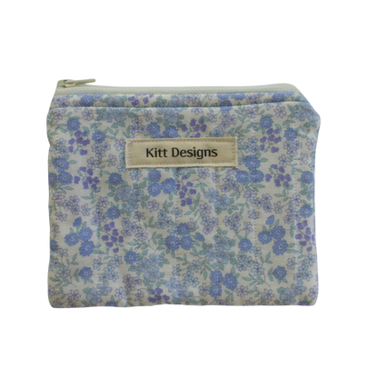 Floral patterned pouch with 'Kitt Designs' label coin pouch