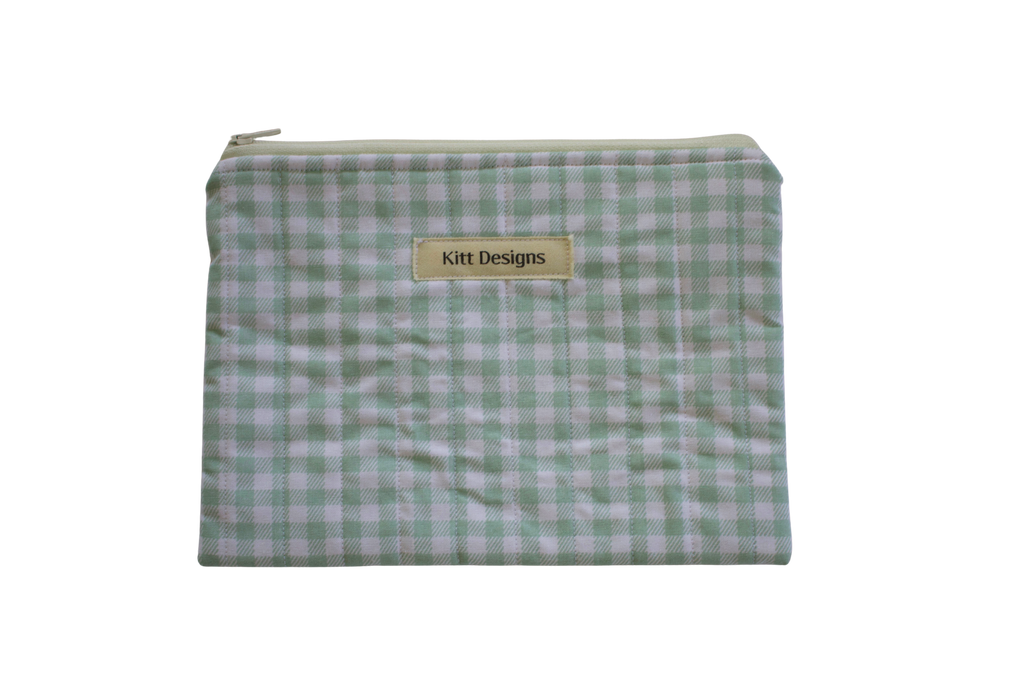 Green checkered pouch with 'Kitt Designs' label zipper pouch green gingham
