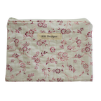 Floral-patterned pouch with 'Kitt Designs' label zipper pouch