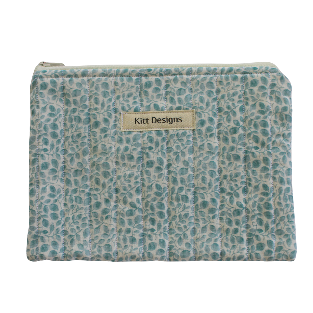 Patterned pouch with 'Kitt Designs' label zipper pouch