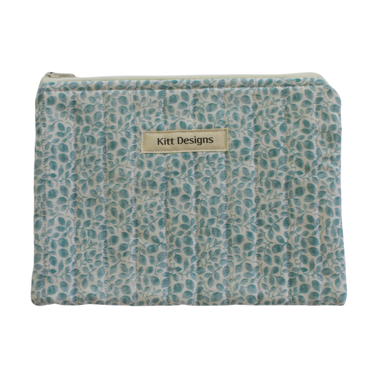 Patterned pouch with 'Kitt Designs' label zipper pouch
