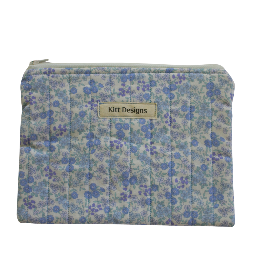 Floral patterned pouch with 'Kitt Designs' label zipper pouch