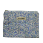 Floral patterned pouch with 'Kitt Designs' label zipper pouch