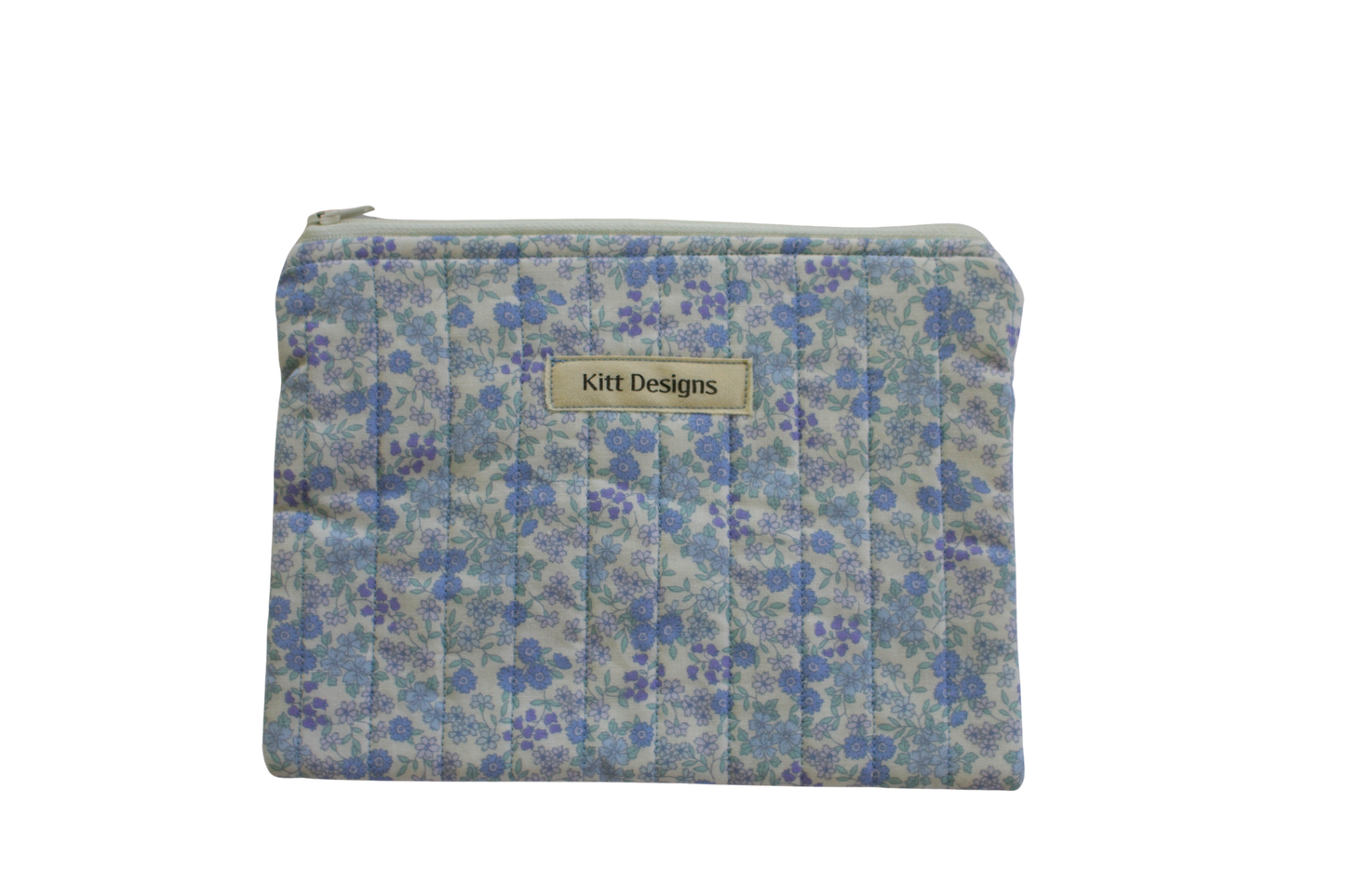 Floral patterned pouch with 'Kitt Designs' label zipper pouch