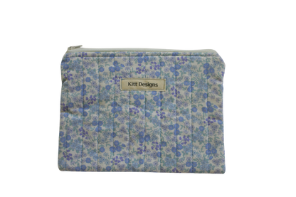 Floral patterned pouch with 'Kitt Designs' label zipper pouch
