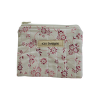 Floral-patterned pouch with 'Kitt Designs' label coin pouch