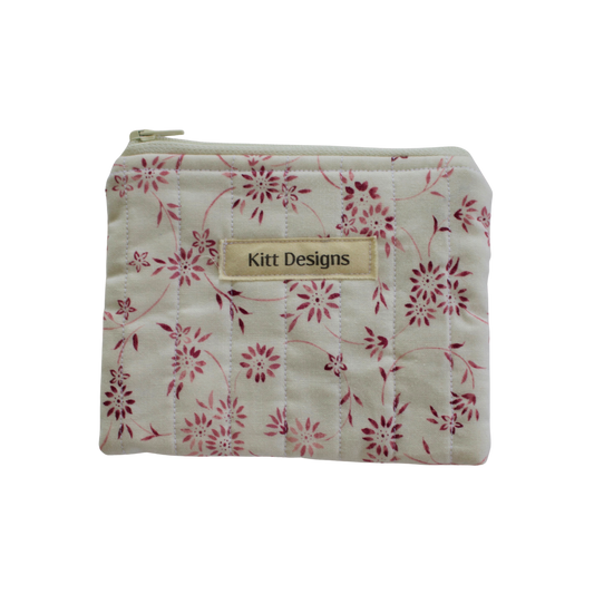 Floral-patterned pouch with 'Kitt Designs' label coin pouch