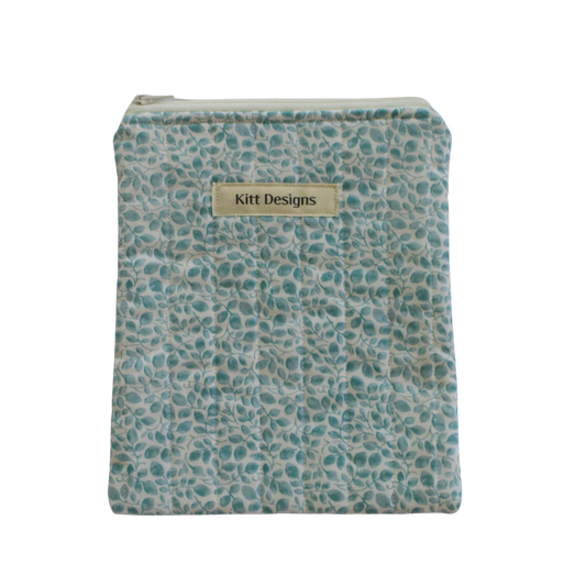Fabric pouch with a pattern and 'Kitt Designs' label kindle pouch