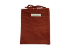 Red checkered pouch with a brand label small book sleeve