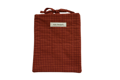 Red checkered pouch with a brand label small book sleeve