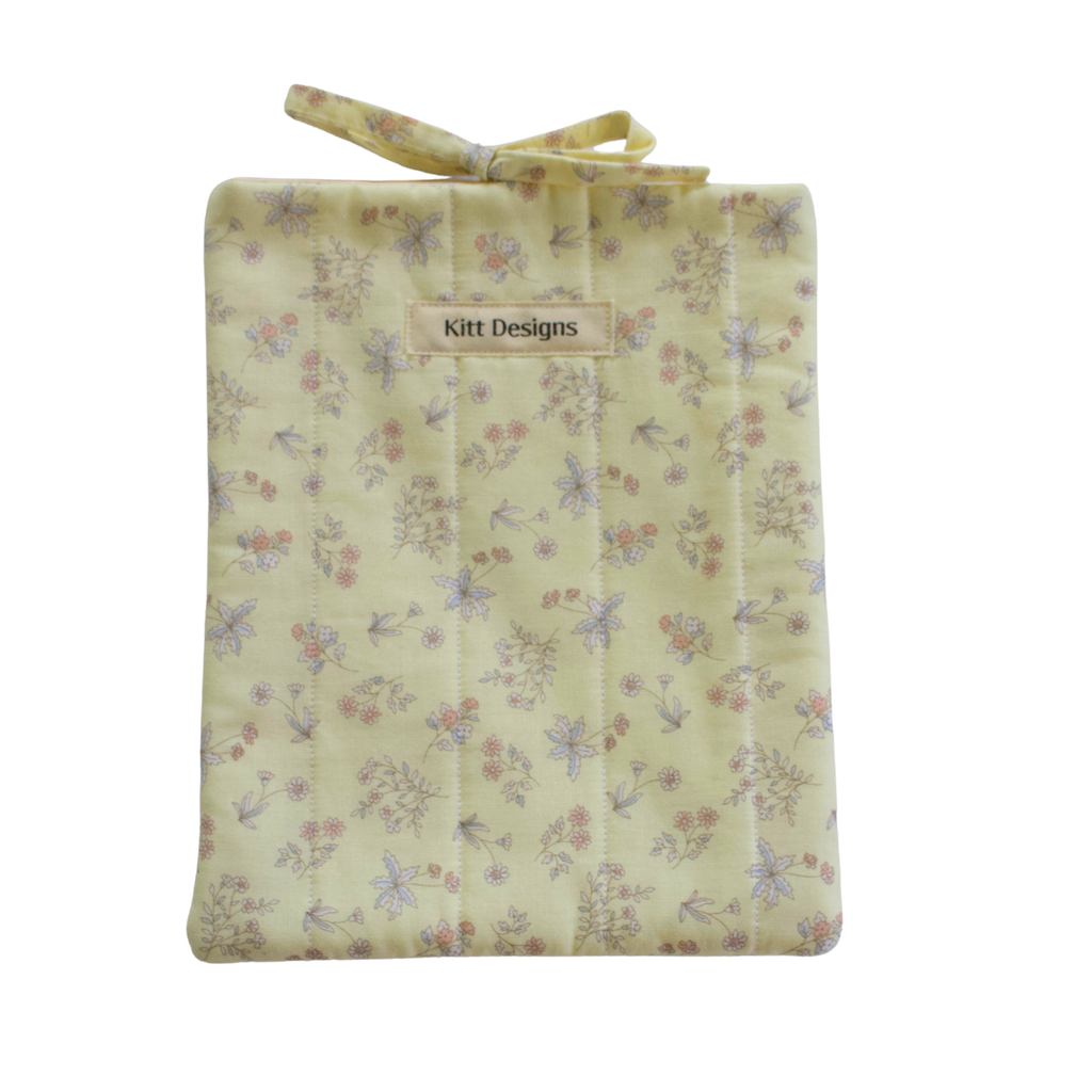 Floral-patterned fabric bag with 'Kitt Designs' small book sleeve