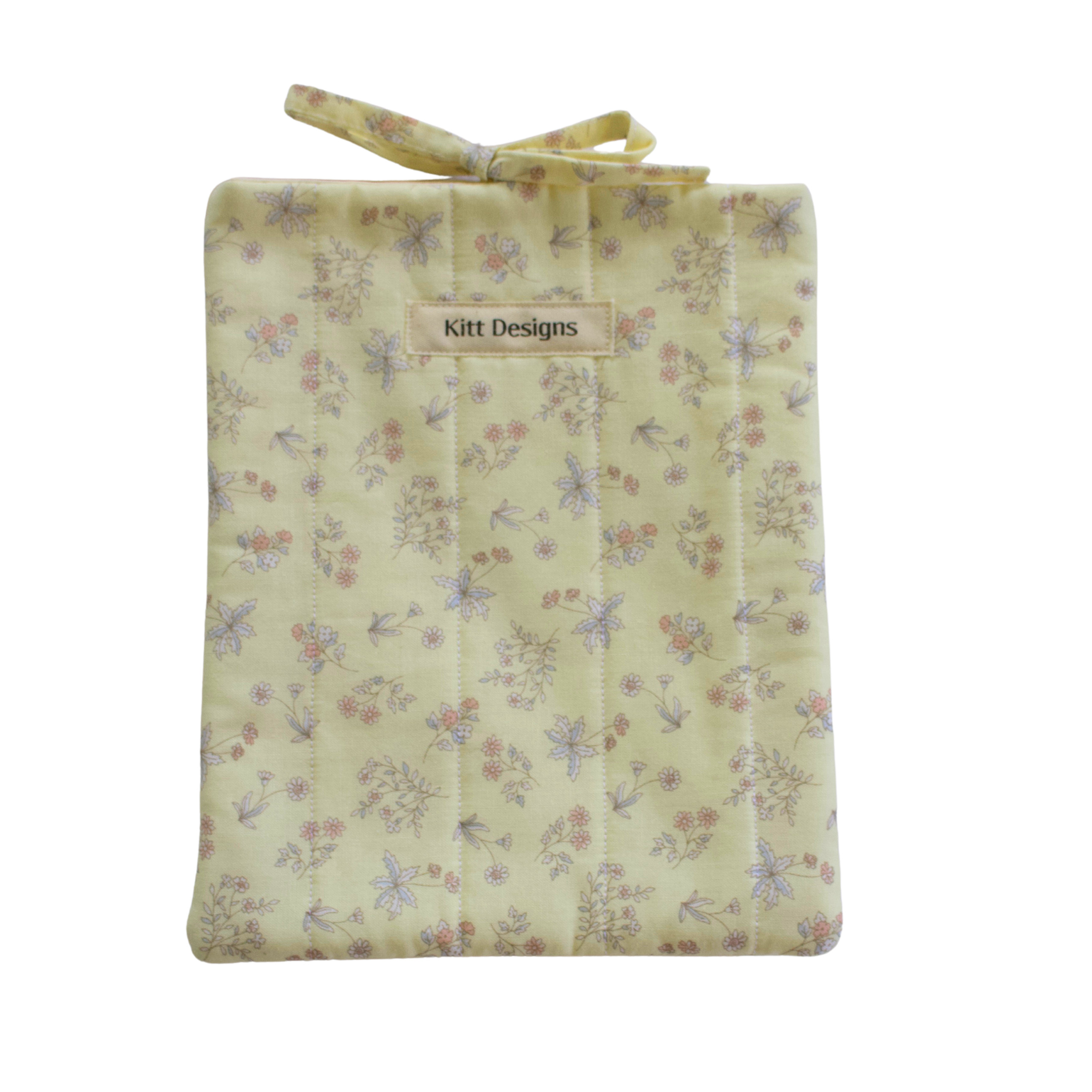 Floral-patterned fabric bag with 'Kitt Designs' small book sleeve
