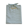 Folded green and white gingham small book sleeve