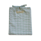 Folded green and white gingham small book sleeve