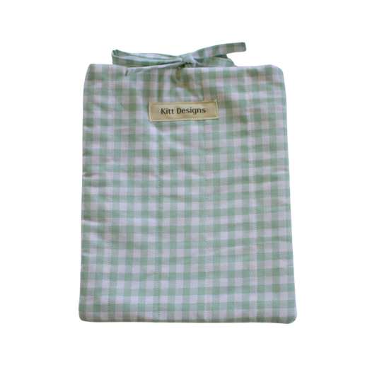 Folded green and white gingham small book sleeve