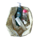 A yellow floral makeup bag filled with various skincare and beauty products. Handmade cosmetics pouch. Toiletry bag. handmade quilted pouch. cosmetic bag.