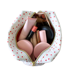 An open white cosmetic pouch with a red heart pattern and gold zipper, shown from a top-down view on a white background. Makeup bag. Handmade Makeup pouch. Handmade quilted pouch